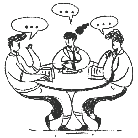 Three people chatting around a table